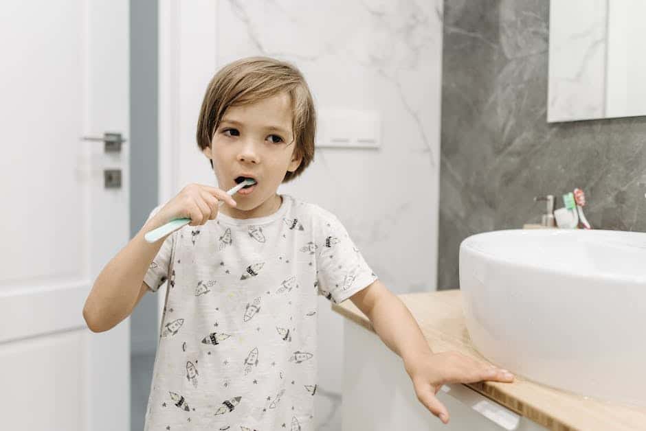 Image depicting a child brushing their teeth with a happy smile.